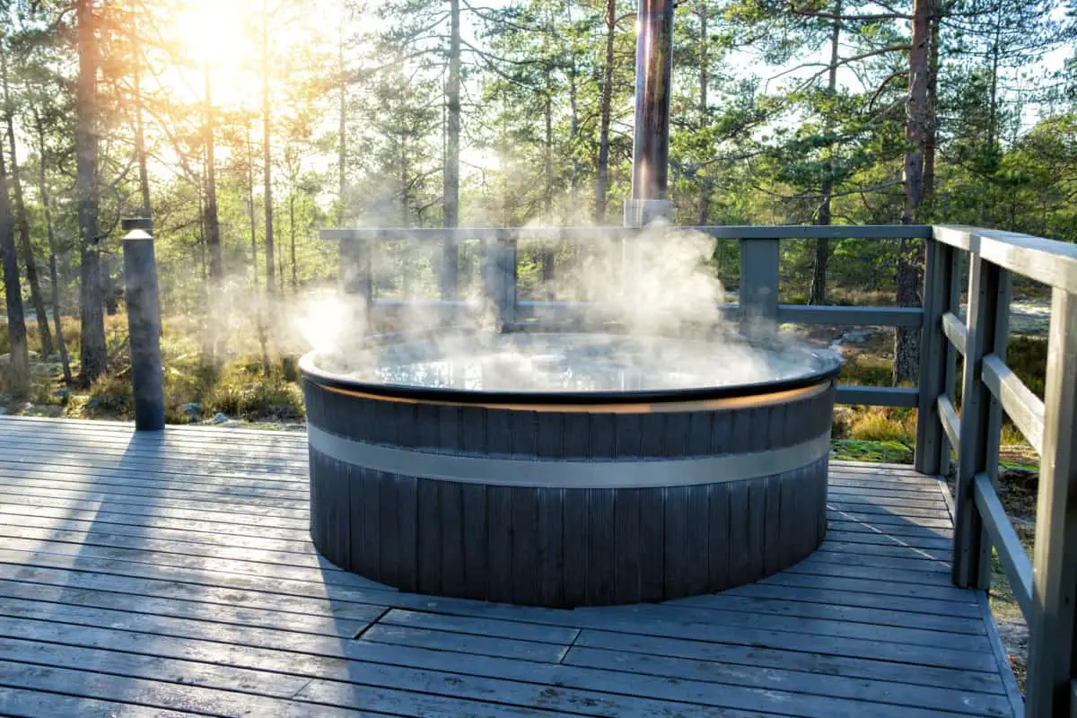 Wood hot tub on deck steaming